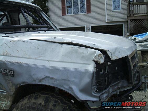 Damaged 1995 Ford Bronco front end with dented hood and fender