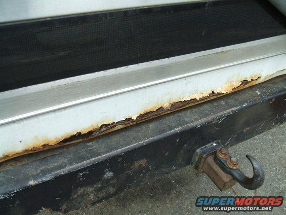 Rear bumper with rust and a tow hitch