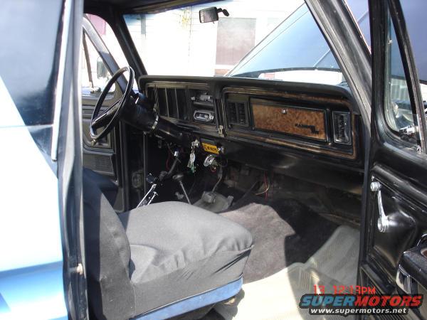 1979 Ford Bronco interior with wood grain trim and black steering wheel