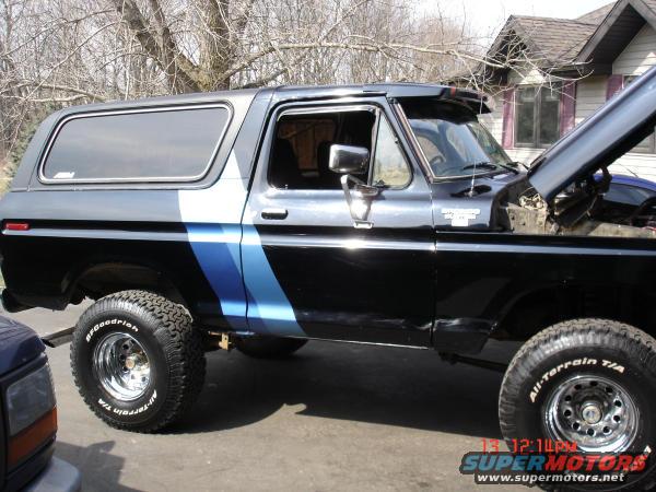 1979 Ford Bronco, black with blue stripe, 3q-front view, hood open