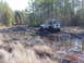 1995 Dodge 1500 - A white Jeep Wrangler navigates a muddy trail surrounded by trees and dry grass.