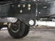 1994 Ford Bronco - Close-up view of aftermarket suspension bracket and components attached to a vehicle's frame.