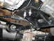 1994 Ford Bronco - Underside view of a vehicle's suspension system, showing a newly installed bracket.