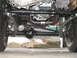 1994 Ford Bronco - The photo shows the front axle, suspension, and exhaust system of a 4x4 vehicle.