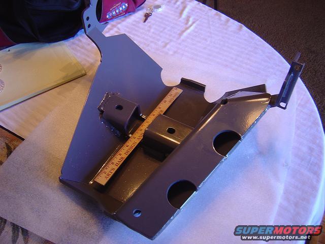 Metal bracket with ruler showing "ACE'S HAIR DESIGN AND"