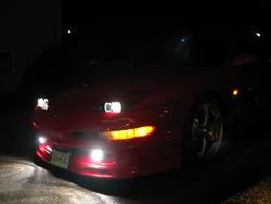 1997 Ford Probe front view at night with headlights and fog lights on