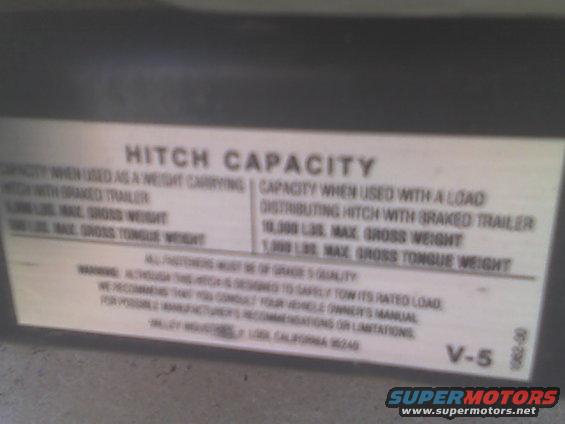 View of the receiver's weight limit label.  5000lbs off a standard hitch and 10000lbs with a weight distributing hitch.  Of course the truck's GCWR is only 11500 because of the small-block engine and four-wheel-drive, so if the truck weighs 5600 like I think it does, then it could only tow 5900lbs.