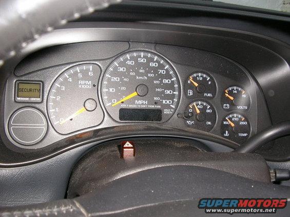 Dashboard with speedometer, tachometer, fuel, oil, volts, and temp gauges. Security message center is visible