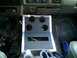 1995 Ford Bronco - Interior view of a vehicle's center console, a custom-built unit with multiple cup holders and exposed wiring.