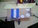1995 Ford Bronco - A wooden console part with blue and white stripes is being worked on with clamps.