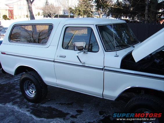 White 1978 Ford Bronco parked outside with hood up