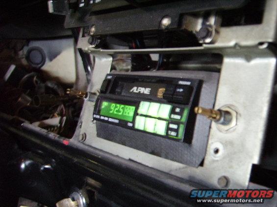 Interior view of an Alpine car stereo with a green digital display showing '92.5'