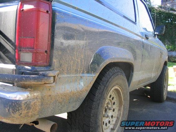 1990 Ford Bronco II rear quarter panel and taillight covered in mud