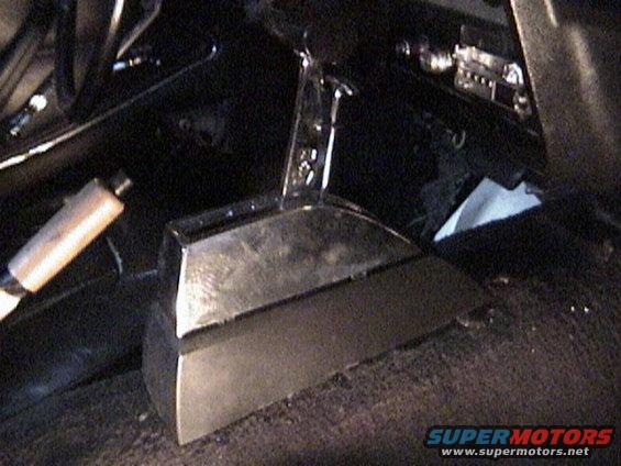 Close-up of a custom shifter in a car's interior. The shifter has a chrome handle and a dark base