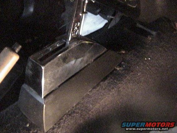 Aftermarket shifter console in a dark car interior