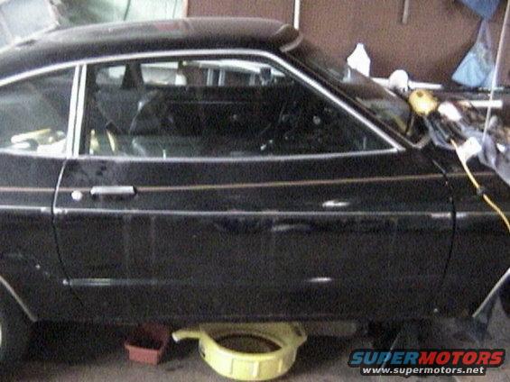1977 Ford Mustang side view, black coupe with gold trim