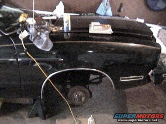 1977 Ford Mustang II fender with wheel well visible, car is on jack stands