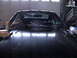 1977 Ford Mustang - Front view of a black 1977 Ford Mustang II, showing the hood and windshield area.