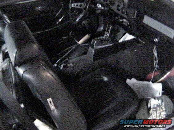 Interior of a 1977 Ford Mustang showing black seats and dashboard