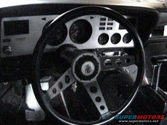 1977 Ford Mustang II interior with a three-spoke steering wheel and a silver dashboard