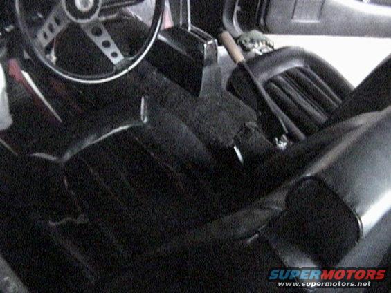 Interior of a 1977 Ford Mustang showing black seats and steering wheel