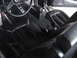 1977 Ford Mustang - The interior of a 1977 Ford Mustang, black seats and a distinctive steering wheel.