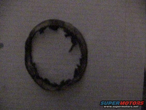 Worn rubber brake seal with visible damage on the inner edge