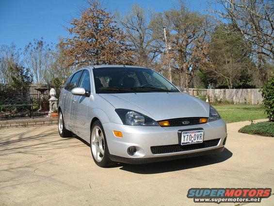 Silver Ford Focus hatchback parked outside on a sunny day. License plate reads Y70-DVR