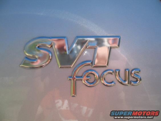 Chrome SVT Focus badge on a light-colored car