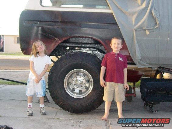 1979 Ford Bronco side view with large tires and two children