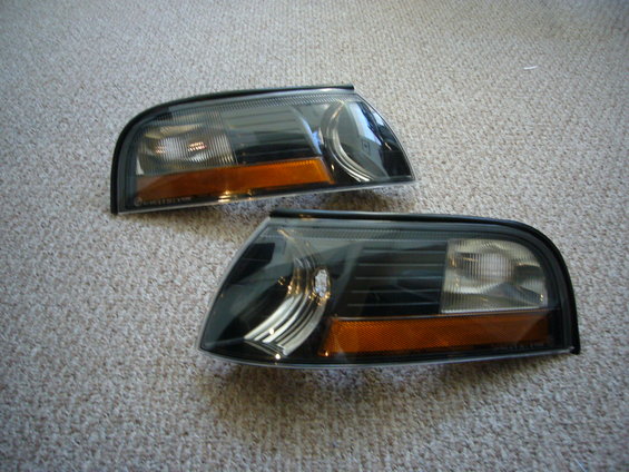 pair of blacked-out headlights with amber turn signals