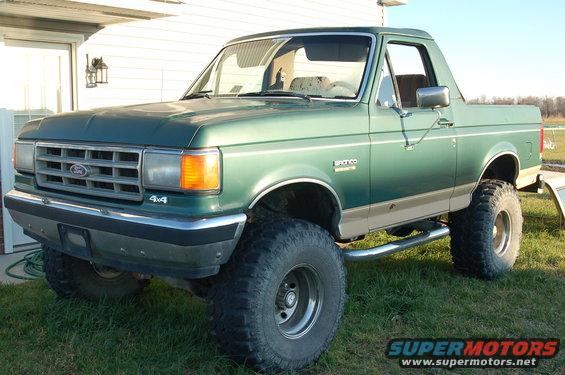 Green lifted Ford Bronco with 4x4 badge on the front fender