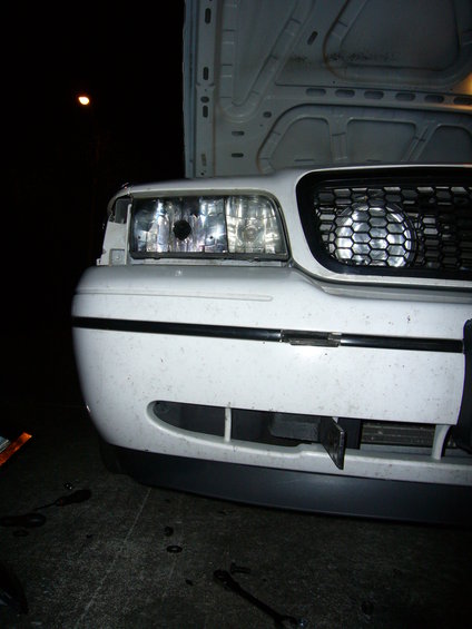 2000 Ford Crown Victoria front end with hood open, showing headlights and grille