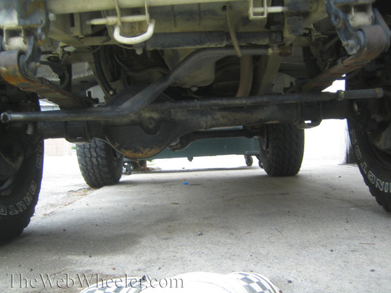Underside view of a 4x4 vehicle's suspension and drivetrain components