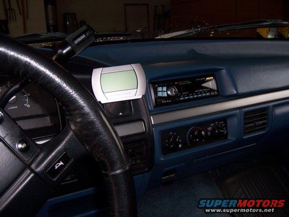 Dashboard view of a vehicle interior, showing the steering wheel, radio, and climate controls