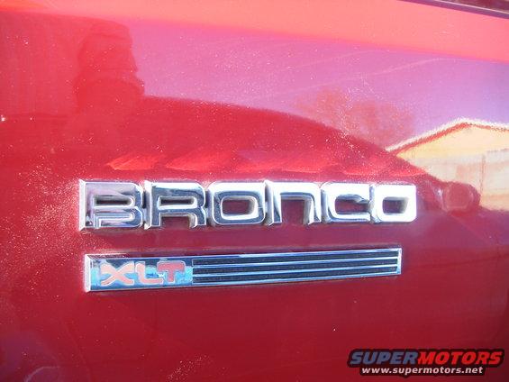 Red vehicle side panel with chrome Bronco and XLT emblems