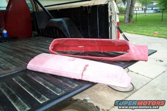 Truck bed with red and pink automotive parts