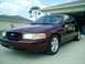 2004 Ford Crown Victoria - Maroon 2004 Ford Crown Victoria parked in front of a garage.