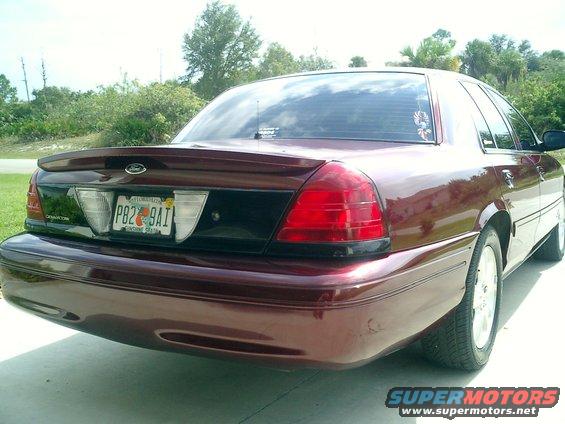 Maroon 2004 Ford Crown Victoria rear view with spoiler and Florida plates