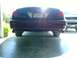 2004 Ford Crown Victoria - Rear view of a red 2004 Ford Crown Victoria, showing its taillights and license plate.
