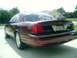 2004 Ford Crown Victoria - Rear view of a maroon 2004 Ford Crown Victoria parked in a driveway.