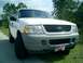 2002 Ford Explorer - Front view of a white 2002 Ford Explorer SUV, a prominent grille and an American flag license plate.