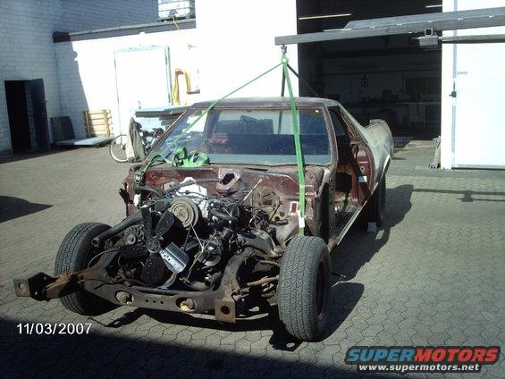 1979 Ford Ranchero project car with engine removed, suspended by straps