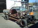 1979 Ford Ranchero - A disassembled 1979 Ford Ranchero is suspended by a forklift, revealing its internal structure and engine bay.