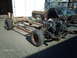 1979 Ford Ranchero - A vehicle chassis and partial body are shown disassembled, with the engine exposed and the body in a state of disrepair.