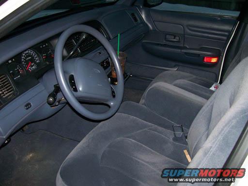 Interior view of a 1999 Ford Crown Victoria, showing the dashboard, steering wheel, and seats
