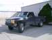 1991 Ford Ranger - This 1991 Ford Ranger pickup truck is parked in front of a metal-sided building with a large green tree to its right.