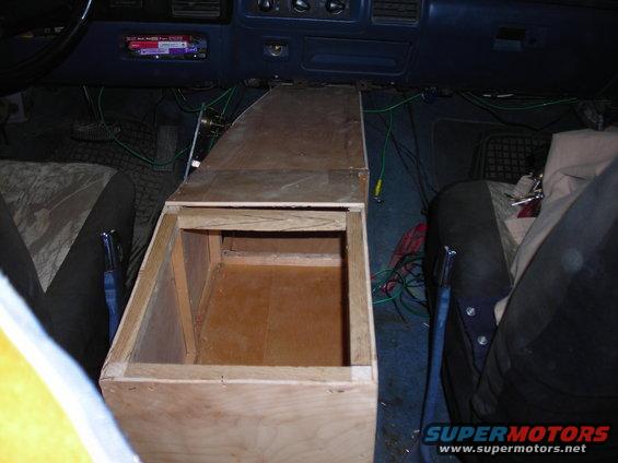 Interior view of a 1994 Ford Bronco with a custom wooden center console and visible wiring