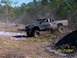 1989 Ford Bronco - A modified pickup truck navigates a challenging off-road course.