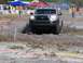 1989 Ford Bronco - A Toyota Tacoma navigates an off-road obstacle course with spectators watching.
